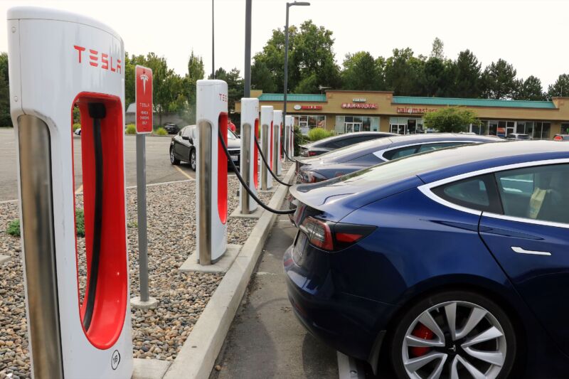 A row of Tesla EVs charging at one of the company's Supercharger fast charging locations.