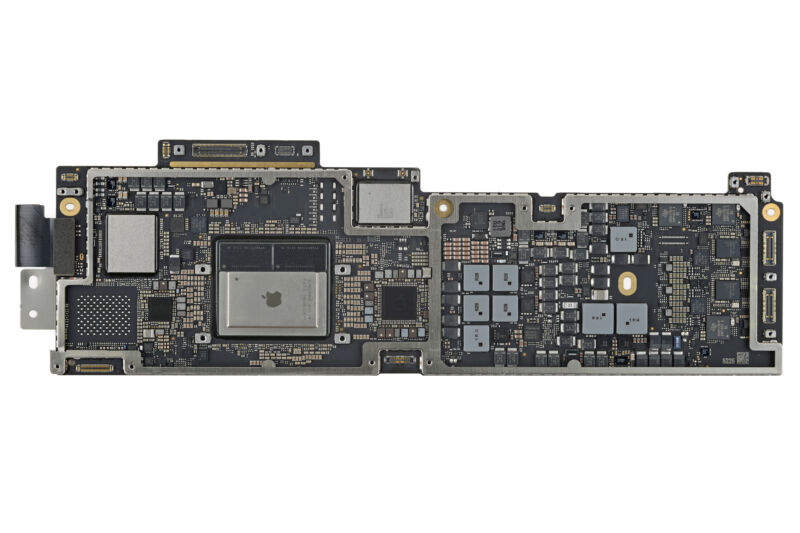 The M2 MacBook Air's logic board. The M2 is the big chip in the center-left with the Apple logo printed on it.