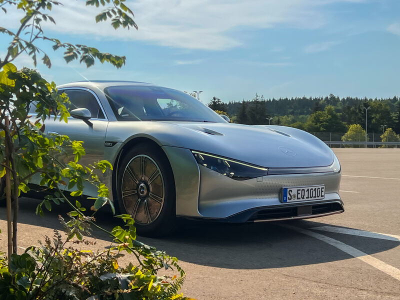 A Mercedes-Benz Vision EQXX seen hiding behind some potted plants