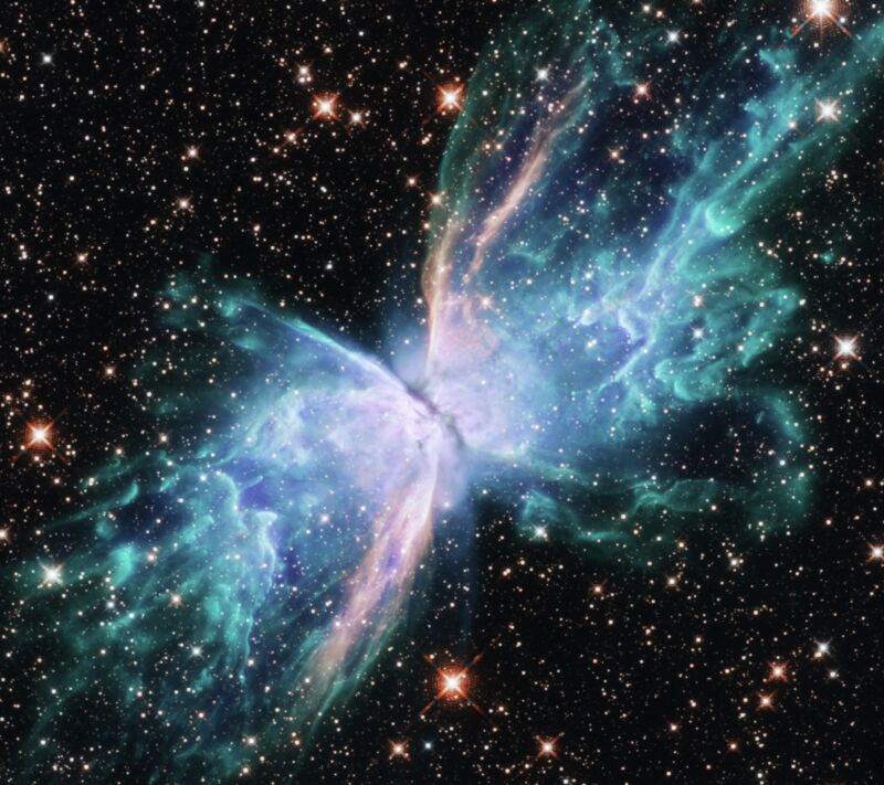 The The Butterfly Nebula, located just under 4,000 light-years from Earth in the constellation Scorpius, is a striking example of a planetary nebula, the final stage in the evolution of a small to medium-sized star. gas and dust that were expelled from the dying star and illuminated from within by the star's remaining core The nebula's symmetrical double-lobed shape is a telltale sign that a companion star helped shape outgoing gases. The primary star and its companion are hidden by the shroud of dust in the center of the nebula. of a small to medium-sized star. The diaphanous 