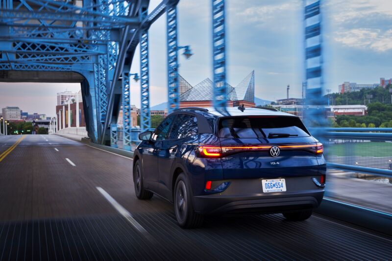 A blue VW ID.4 driving over a bridge