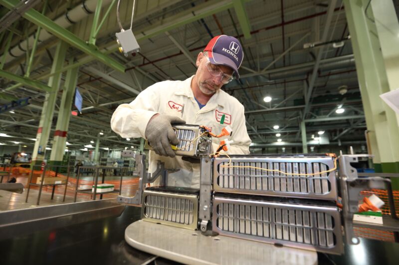 A Honda worker assembles a battery pack.