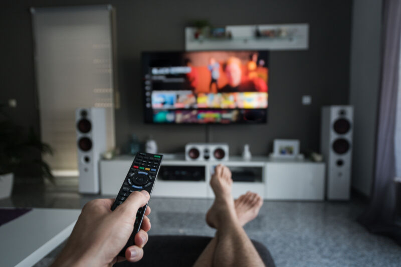 Image of a person in front of a TV.