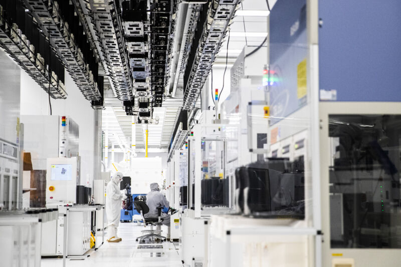 Employees wearing cleanroom suits monitor chemical vapor deposition operations inside the GlobalFoundries semiconductor manufacturing plant in Malta, New York.Semiconductor production plants have become a focal point as that economic recovery from the pandemic is being hampered in some regions by a shortage of some of the critical electronic components needed.