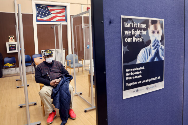 An Army veteran waits the recommended 15 minutes to see if he will have any adverse reactions after receiving his second COVID-19 booster shot at Edward Hines Jr. VA Hospital on April 1, 2022, in Hines, Illinois.