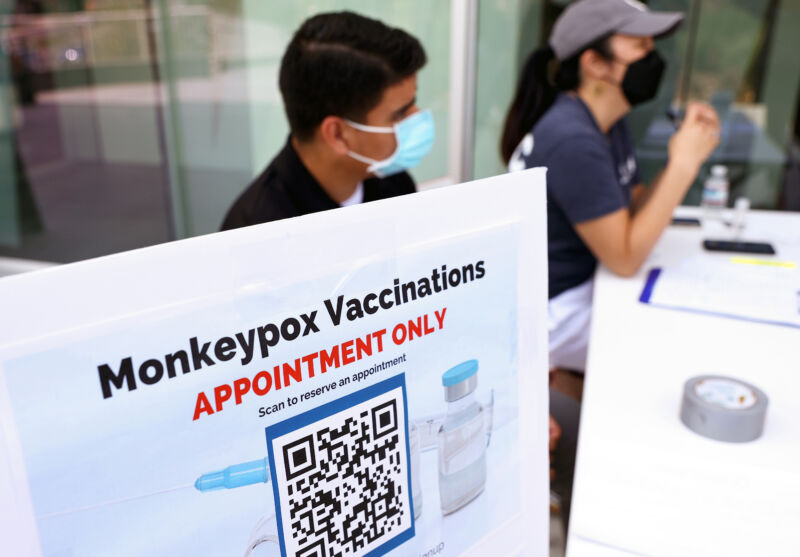 Health workers sit at a check-in table at a pop-up monkeypox vaccination clinic, which was opened by the Los Angeles County Department of Public Health at the West Hollywood Library on August 3, 2022, in West Hollywood, California.