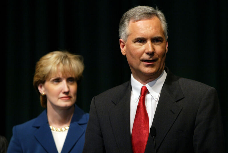 Tom McClintock speaks to reporters with his wife Lori after participating in a debate at California State University, Sacramento September 24, 2003 in Sacramento, California.