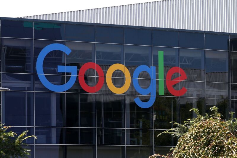 At Google headquarters, the company's logo is seen on the glass exterior of a building.