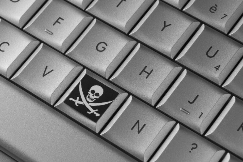 A computer keyboard with a pirate's skull and crossbones symbol on one of the keys.