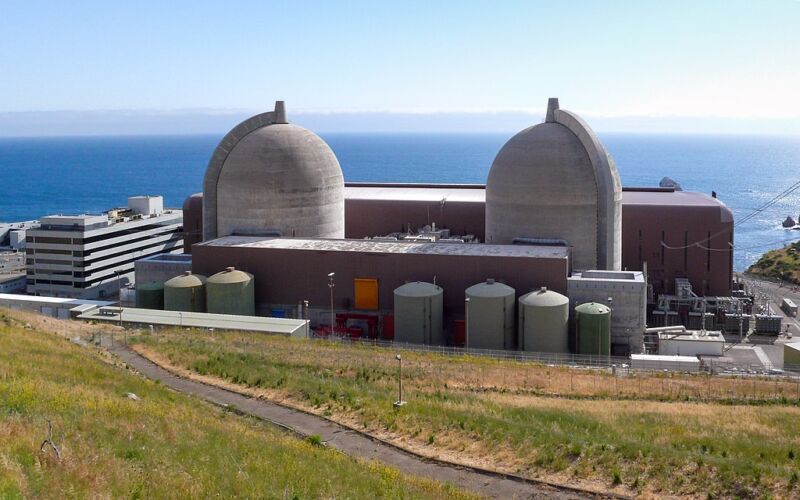 Image of two domed concrete shells in front of the ocean.