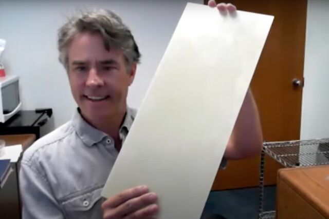 John Dorgan of Michigan State University holds up a panel made from a new recyclable resin. 