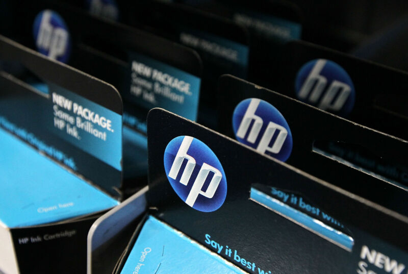 Packages of HP ink cartridges ares displayed at a Best Buy store