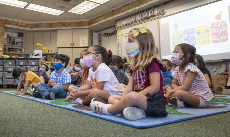 Students listen to their teacher during their first day of transitional kindergarten at Tustin Ranch Elementary School in Tustin, Calif., on Wednesday, August 11, 2021.
