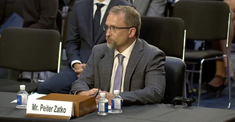 Peiter Zatko sits at a table in front of a microphone while testifying at a Senate hearing.