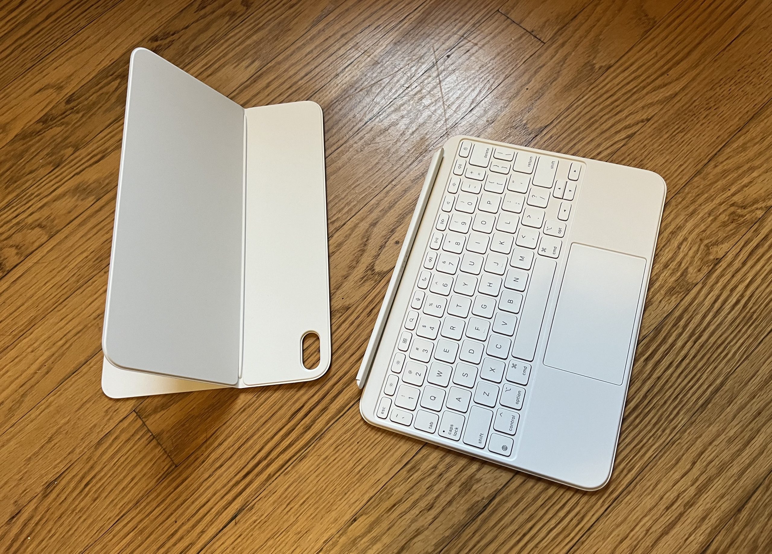 The two pieces of the Magic Keyboard Folio on a wood surface
