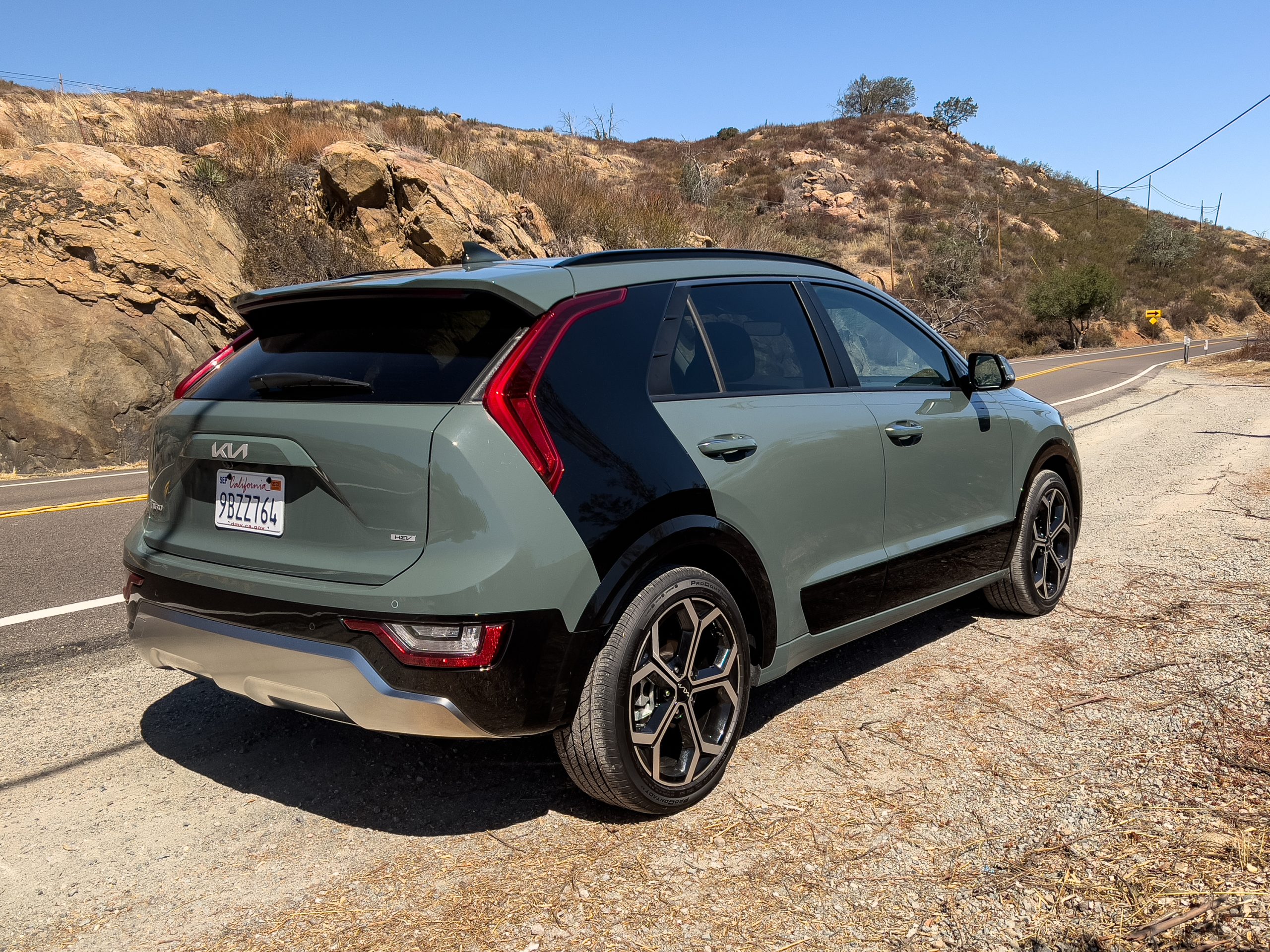 A green Kia Niro hybrid seen from behind