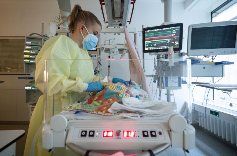 An intensive care nurse cares for a patient suffering from respiratory syncytial virus.