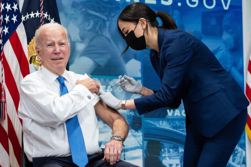 US President Joe Biden receives the latest COVID-19 booster shot in the South Court Auditorium of the Eisenhower Executive Office Building, next to the White House, in Washington, DC, on October 25, 2022. 