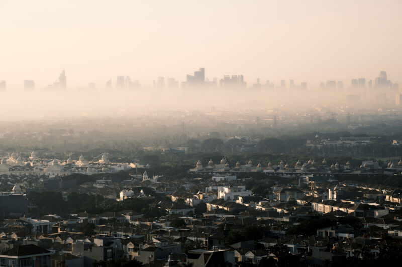 Image of a city skyline partially obscured by pollution.