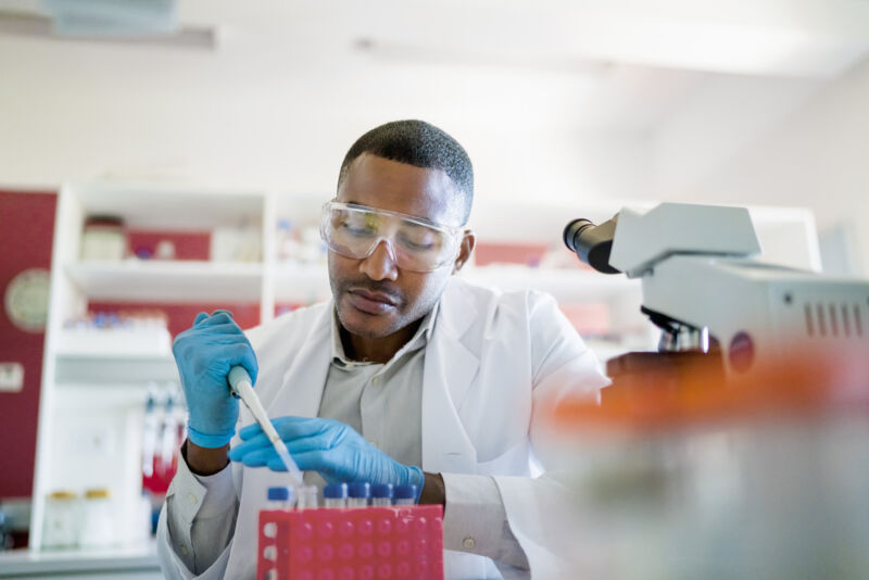 Image of a person using a pipette to transfer solutions