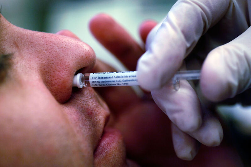A man receives an H1N1 nasal flu spray vaccine at an urgent care center on October 16, 2009, in Lake Worth, Florida.  