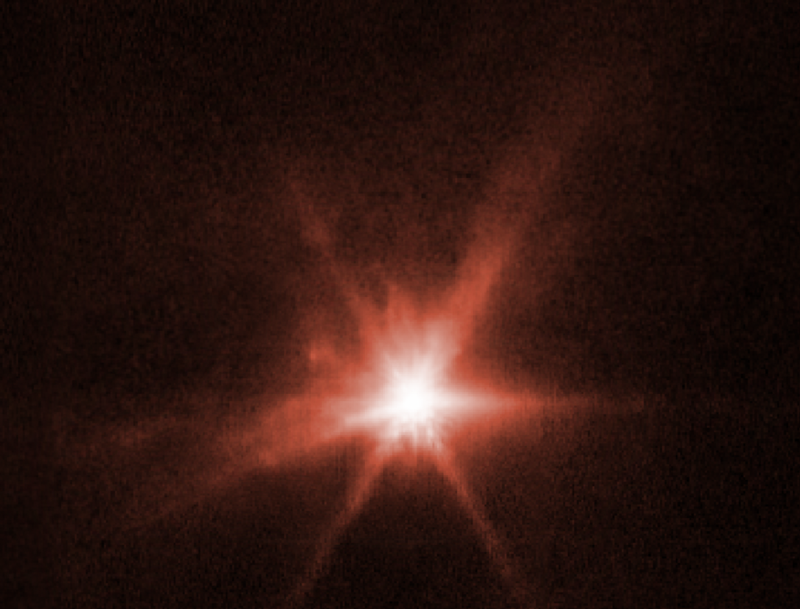 Red image showing lots of plumes of material originating from a small body.
