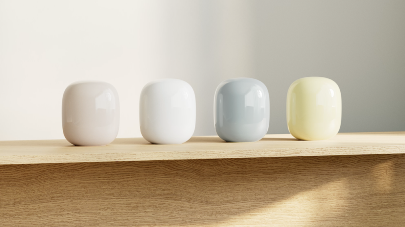 Nest Wifi Pro units in four colors (pink, white, blue-gray, light yellow) lined up.