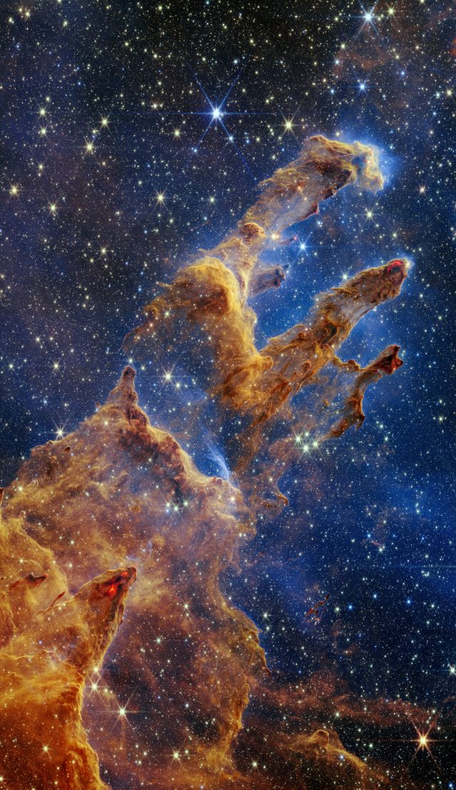 The Pillars of Creation are set off in a kaleidoscope of color in the James Webb Space Telescope’s near-infrared-light view. 