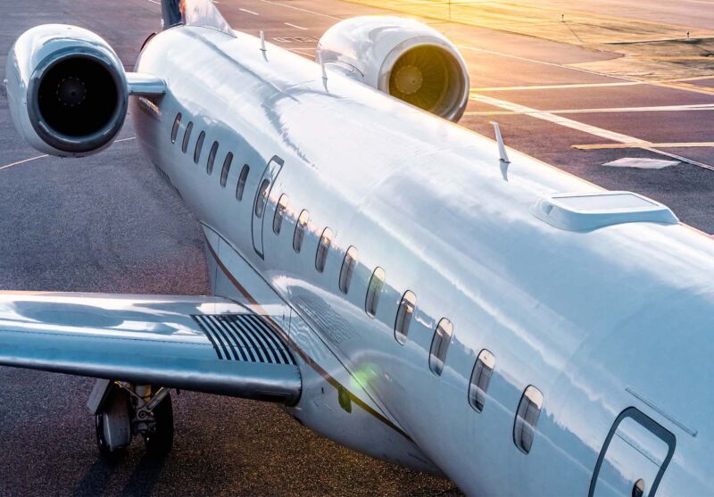 An airplane with a Starlink Aviation terminal installed on the top. The terminal is flat and rectangular, and doesn't add much bulk to the top of the aircraft.