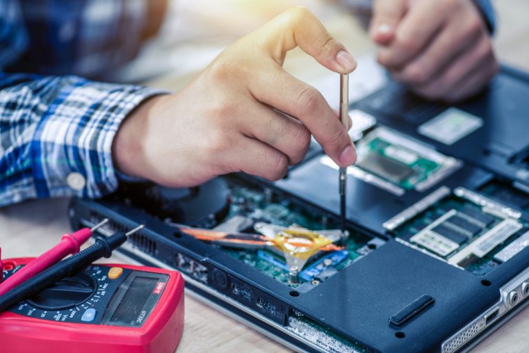 Technician working on a computer motherboard