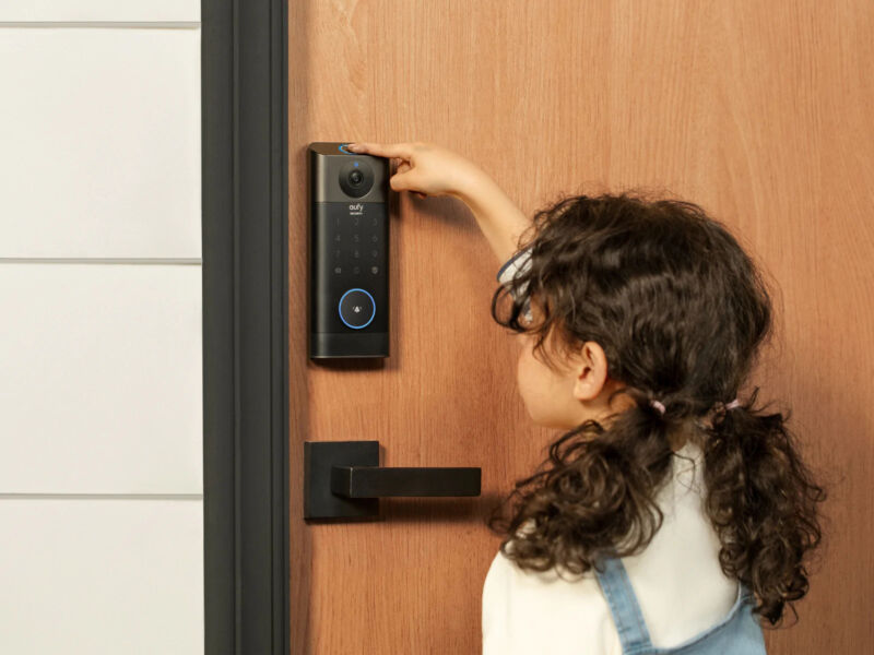 Young girl looks into Eufy doorbell lock camera