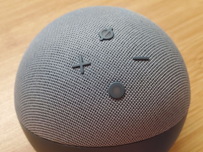 Close-up view of an Amazon Echo Dot device sitting on a table.