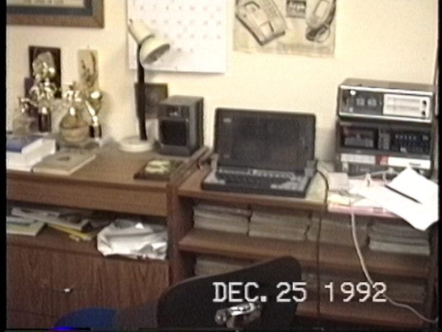 Still image from a 1992 camcorder home video of Benj's first BBS computer, the Tandy 1800HD laptop.