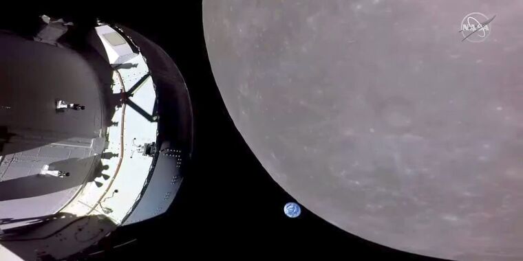 Orion soars around the Moon with a lonely Earth in the distance