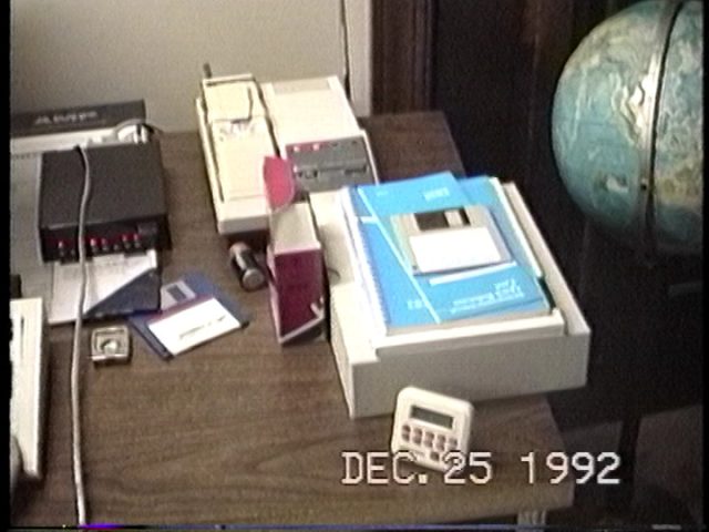 The side of Benj's desk with the Zoom 2400 modem active beside the PC.