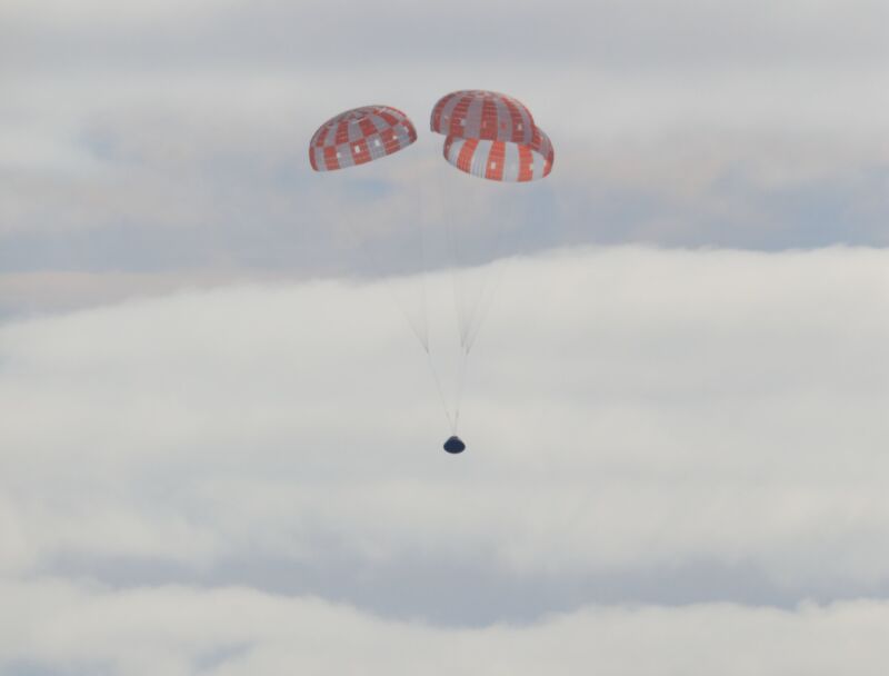 NASA's Orion spacecraft descends toward the Pacific Ocean after a successful mission in December.
