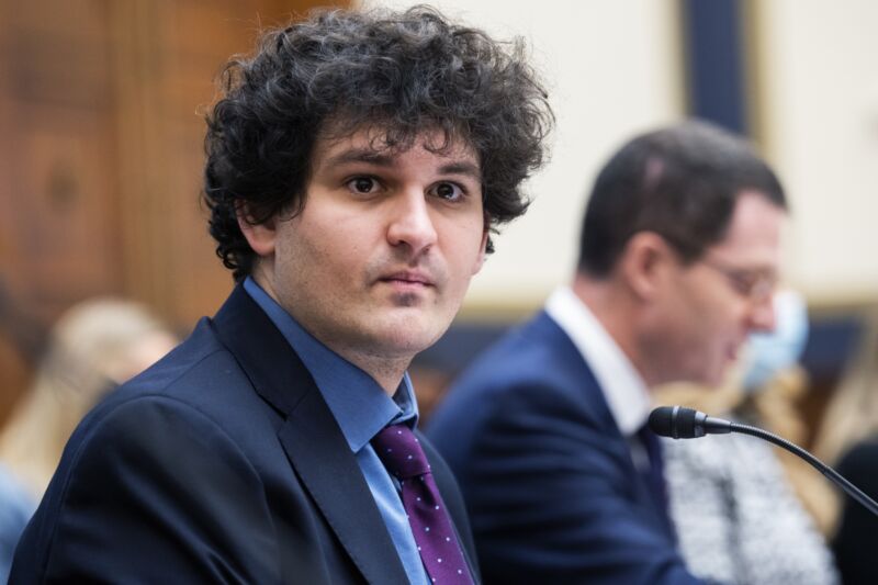 Sam Bankman-Fried sits at a table while testifying during a Congressional hearing in 2021.