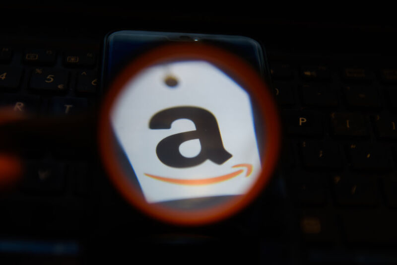In this photo illustration an Amazon logo seen displayed on
