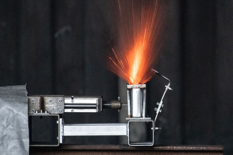 Lithium ion battery in a press to demonstrate their fire-causing potential