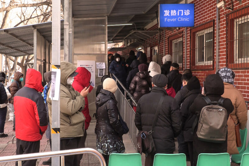 This frame grab from AFPTV video footage shows people queueing outside a fever clinic amid the Covid-19 pandemic in Beijing on December 14, 2022. 