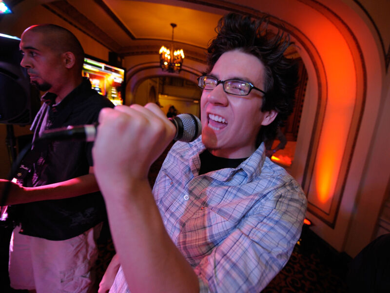 Man singing excitedly at a Rock Band premiere party