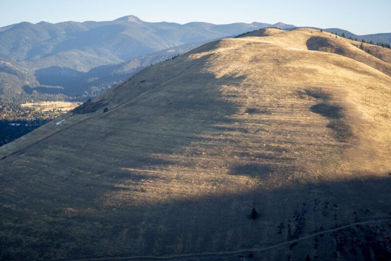 Image of a grassy hill with a series of natural steps carved into it.