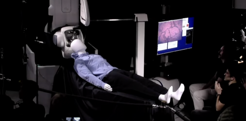 Image of a mannequin on a reclining table, with equipment surrounding its head.