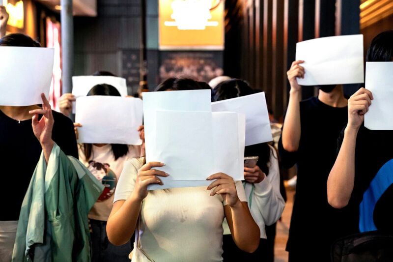 Demonstrators cover their faces with sheets of blank paper while protesting China's zero-COVID policy in Hong Kong on November 28, 2022.