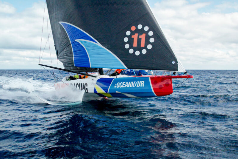 A brightly painted racing yacht at speed