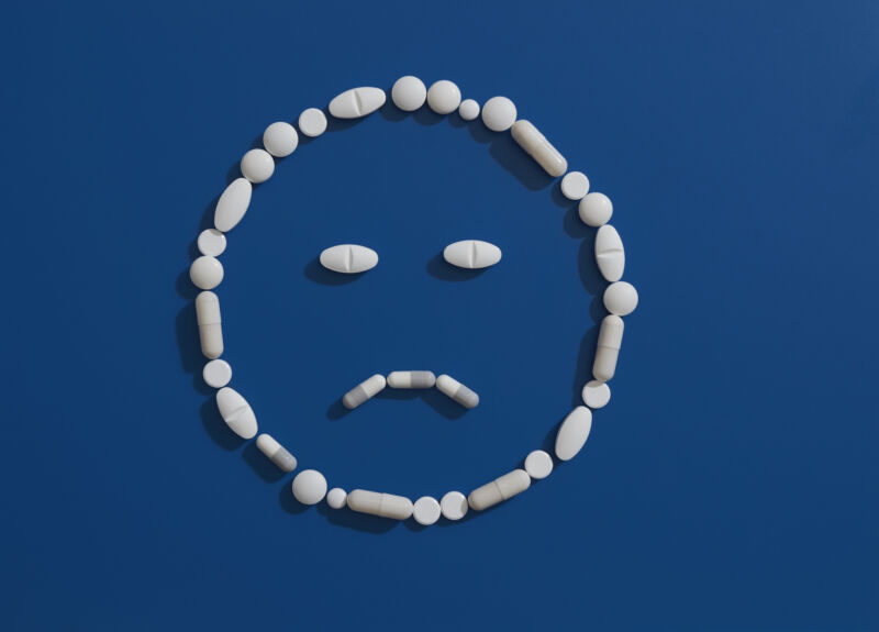 It is an image of a frowning smiley face and the lines are drawn using pills.