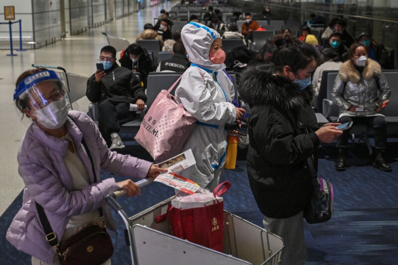 A passenger wearing protective clothing amid the COVID-19 pandemic waits to board a domestic flight at Shanghai Pudong International Airport on January 3. 