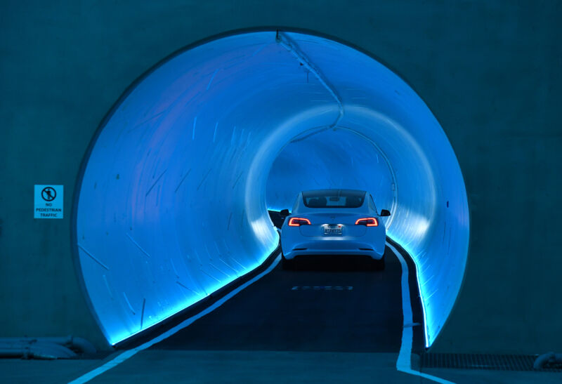 A Tesla car drives through a tunnel in the Central Station during a media preview of the Las Vegas Convention Center Loop on April 9, 2021 in Las Vegas, Nevada