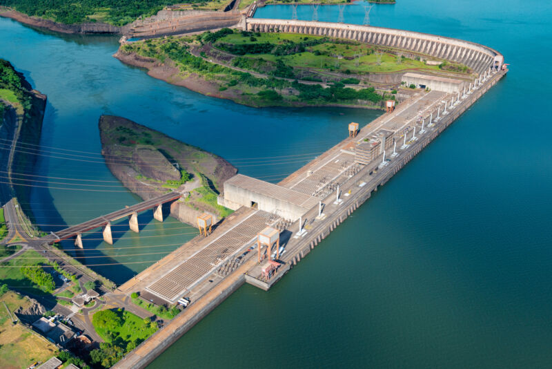 Image of a large hydroelectric dam and power lines.