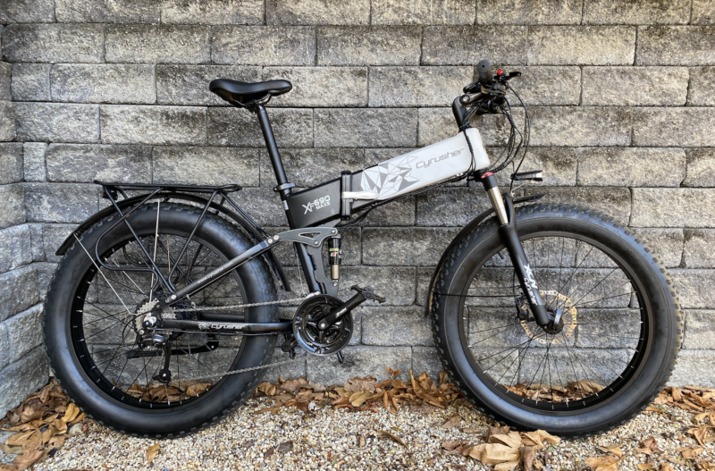 Image of a mountain bike leaned up against a stone wall.
